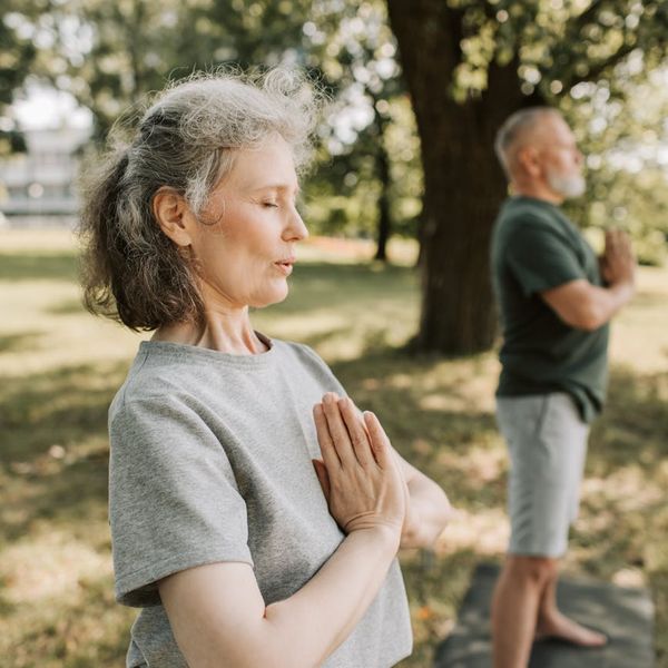 Person meditating peacefully in a serene environment.